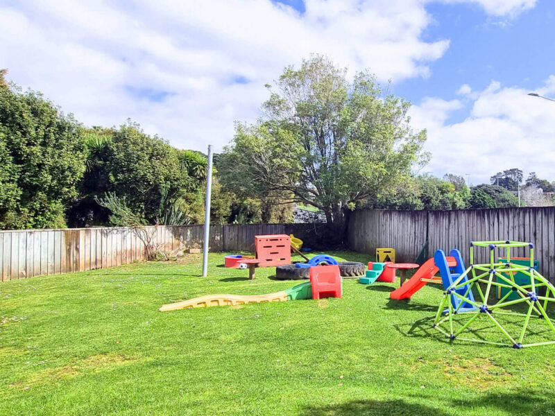 Lawn area by the hall, with children's play equipment